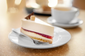 Delicious cheesecake in sauce on table closeup