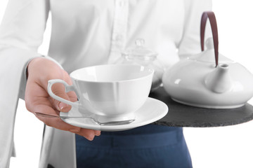 Waiter holding tray with cup and teapot on white background