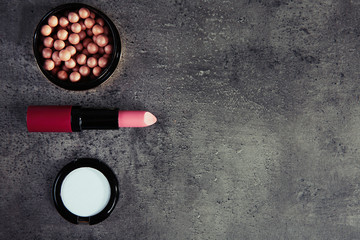 Makeup cosmetics on grey background, copy space