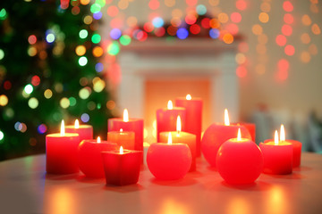 Candles on table on Christmas tree background