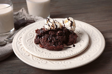 Served table of chocolate lava cake with ice-cream and milk