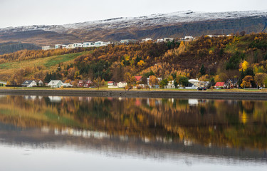 Reflection of  Akureyri city Iceland with snow mountain range background autumn season