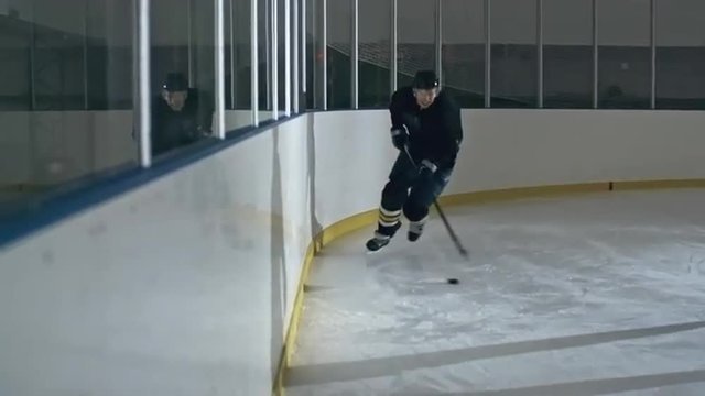 Hockey player handling puck whiles his opponent bumping into him