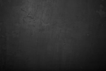 Highly detailed and empty black concrete wall. Dark background, horizontal