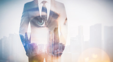 Photo of woman eye and businessman in suit. Double exposure skyscraper on the background. 