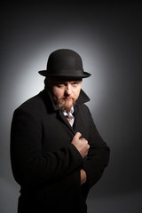 A man in a bowler hat with a beard