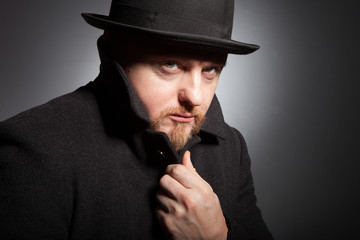 A man in a bowler hat with a beard