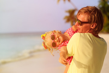 father and cute little daughter at beach