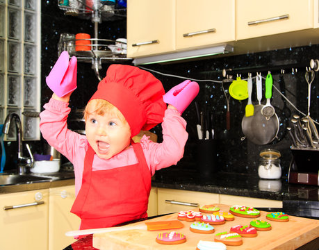 little girl making easter cookies in kitchen