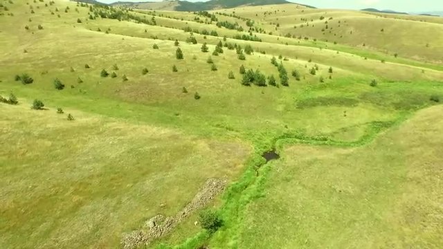 4k Aerial  Flight over a green grassy rocky hills. Serbia,Zlatibor