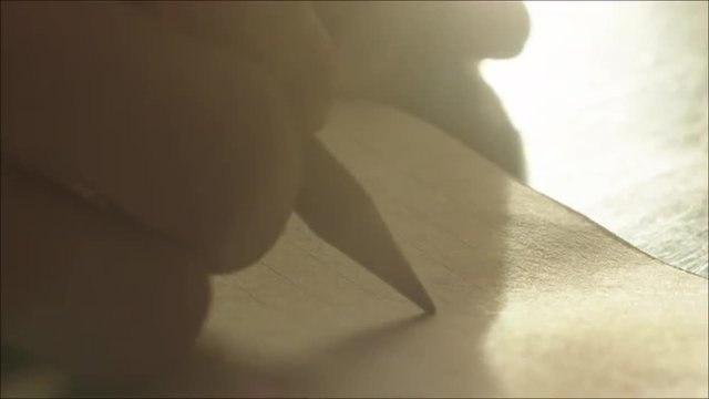 Man Finishing Letter and Signing It