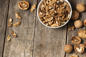 Obraz premium walnuts on rustic old wooden table