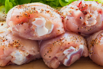 Raw Chicken Drumsticks with salad and pepper