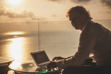 Blond businessman is working on laptop