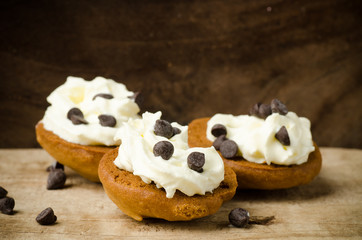 Homemade cookies with whipping cream and chocolate chip on top