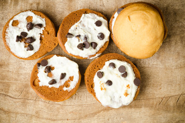 Obraz na płótnie Canvas Homemade cookies with whipping cream and chocolate chip on top