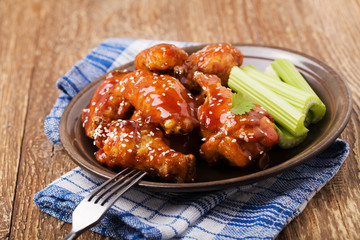 Baked chicken wings in honey sauce sprinkled with sesame seeds.