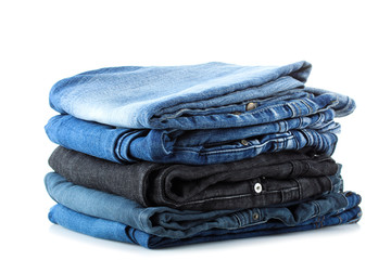 the stack of folded high quality jeans isolated on white background
