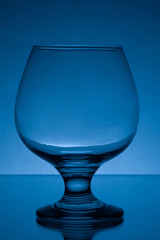 empty cognac glass studio light blue shot 7