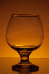 empty cognac glass studio light yellow shot 8