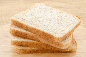 fresh bread wheat in the wooden board.