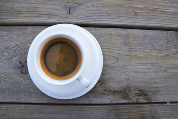 Cup of Americano on wooden table.