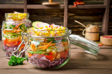 Vegetarian Rainbow salad in a glass jar for summer picnic