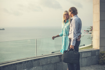 Businessman and his wife on the ocean view background