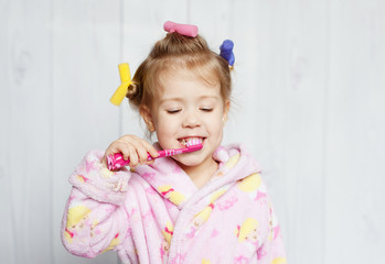 little girl brushing her teeth