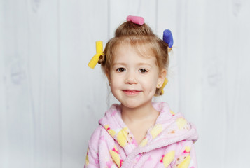 little girl with curlers on her head