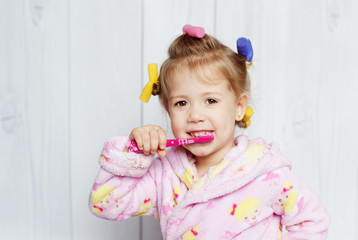 Fototapeta premium little girl brushing her teeth
