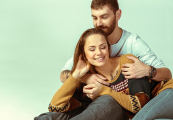 Loving couple on grey background. Studio shot