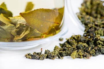 close-up of spilled tea Tie Guan Yin Tea and brewed tea in a tea