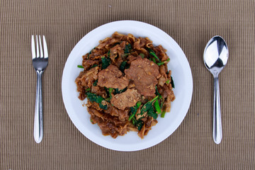 Stir fried flat noodle and pork with dark soy sauce (Thai people called Pad See Ew)
