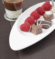 Assorted chocolate candies with raspberries