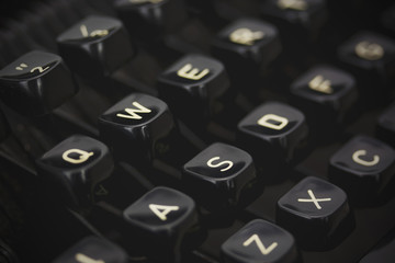 Close up of lettered keys on an old typewriter. Vintage filter a