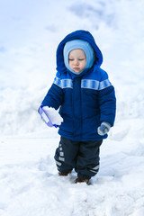 Fototapeta na wymiar Cute baby boy playing with snow toy shovel