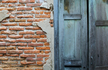 Half frame wooden blue door and brick wall