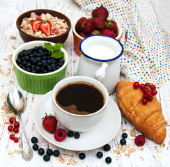 Fresh berries, coffee and croissant