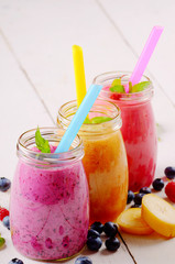 Assorted fruit shakes on white table