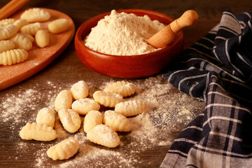 Uncooked homemade potato gnocchi on a rustic table