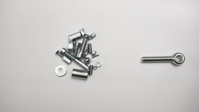 Assorted nuts, bolts, anchor bolts, shims, screws and wing nuts. Game of elements in motion. Time lapse