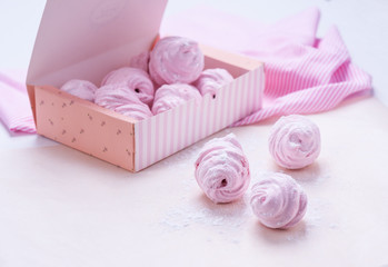Berry marshmallow in a gift box on a pink background