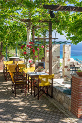 Shaded greek cafe terrace overlooking the sea gulf