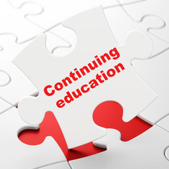 Learning concept: Continuing Education on puzzle background