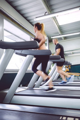Fototapeta na wymiar People in motion during a treadmill training