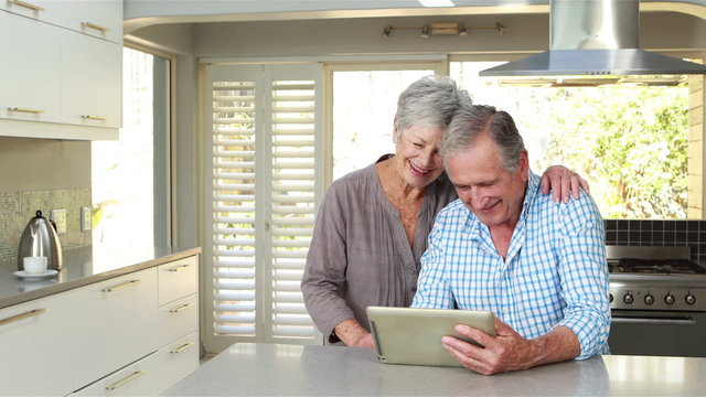 Senior couple using tablet pc