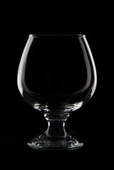 Empty cognaci  glass on black background studio shot