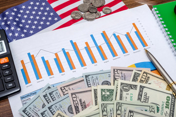 Business and profits concept with chart, usa dollar, coins and  notebook