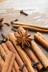 cinnamon sticks, star anise and cloves on wooden background